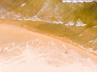 Aerial view of a beach with sand and waves, in Denia, Spain