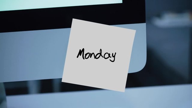 Monday. Days of the week. The inscription on the sticker on the monitor. Message. Motivation. Reminder. Handwritten text written with a marker. Color sticker. A message for an employee, a colleague