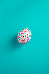 Funny multicolored easter eggs hand painted in blue background.