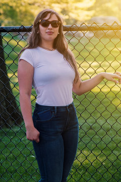 portrait of young woman in the park outdoor smile face model beauty cute attractive pretty handsome appealing alluring fancy smashing sunglasses lifestyle