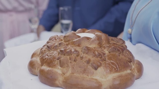 Fresh bread with salt inside holds a woman.