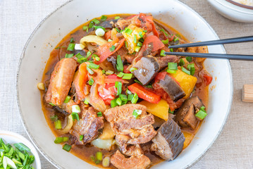 Fried pork with eggplants and sweet peppers in a large bowl - a traditional Chinese dish