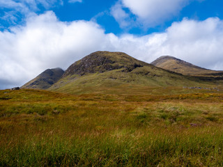 mountains on grassland on a sunny day