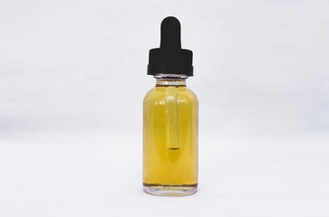 glass bottle with yellow liquid