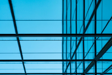 Perspective view of modern futuristic  glass building abstract background. Exterior of office glass building architecture. Reflection in transparent glass of business building. Company glass window.