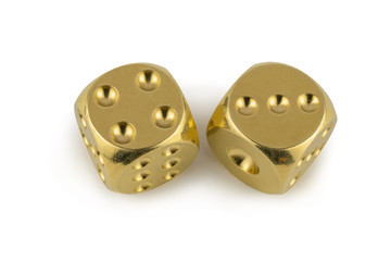 Two golden dices closeup isolated on white background. Four and three, with a shadow.