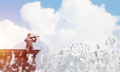 Handsome businessman play his melody and symbols fly around in air