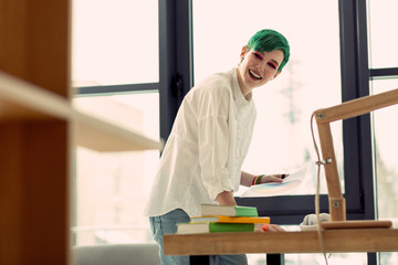 Delighted happy woman enjoying her creative job