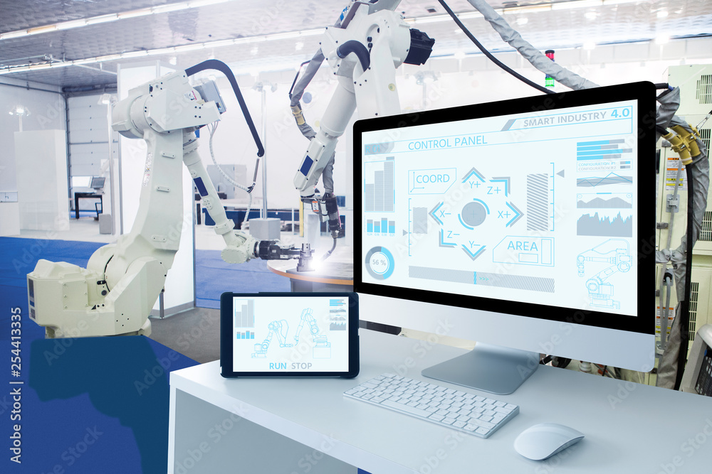 Poster Computer and digital tablet for control of robots in a smart factory. Smart industry 4.0 concept