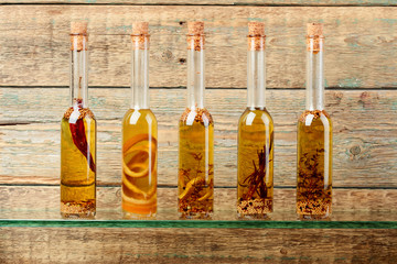 Bottles of olive oil with herbs and spices.