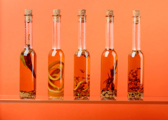 Bottles of olive oil with herbs and spices.