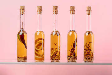 Bottles of olive oil with herbs and spices.