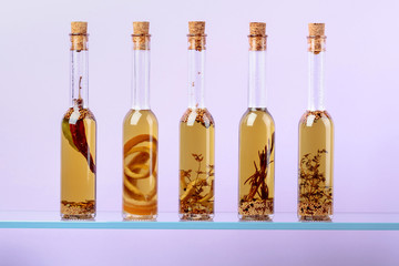 Bottles of olive oil with herbs and spices.