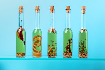 Bottles of olive oil with herbs and spices.
