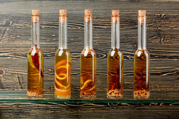 Bottles of olive oil with herbs and spices.