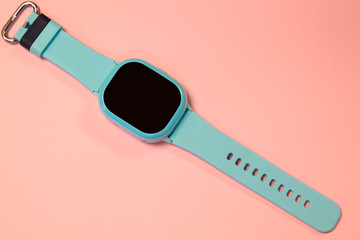 flat lay image of kids smart watch on pastel pink background