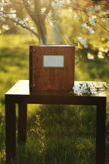 wooden photobook on the table. place for the inscription