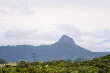 Fototapeta premium Brazilian landscape, road trip in the Espirito Santo state. Wide valleys, nice greenery of atlantic forest and mountains in the background