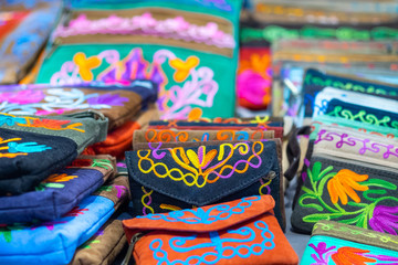 Fototapeta na wymiar Handmade embroidered handbags for sale at handicraft market
