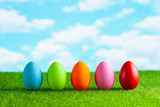 Easter eggs on the grass and blue sky background
