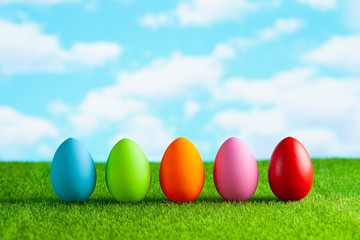 Easter eggs on the grass and blue sky background