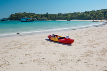 Red canoe on a beach
