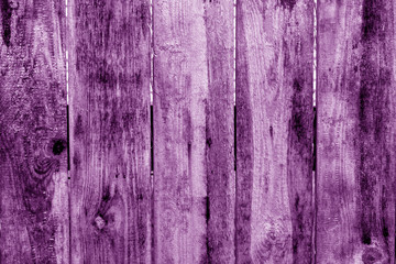 Old grunge wooden fence pattern in purple tone.