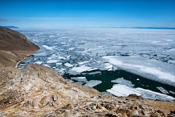 View above big beautiful lake Baikal with Ice floes floating on the water, Russia