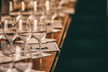 White rose and red wine glasses prepared for tasting.