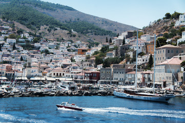 Fototapeta na wymiar The panoramic view of Greek island Hydra with a motor boat on the foreground, edited in Instagram style. Perfect wedding location. 