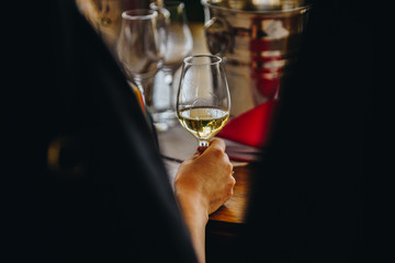 A Glass of White Wine at a Table Tasting