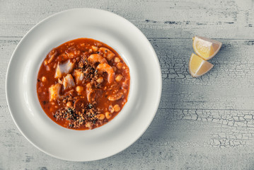 Portion of spanish fish and chorizo soup