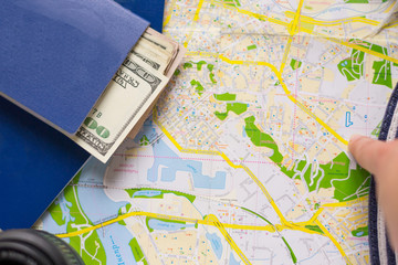 Point of destination on map in traveling. Passport, cash and plans for going. Travel accessories for navigation