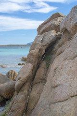 Green water and granite boulders on a beach in Sardinia