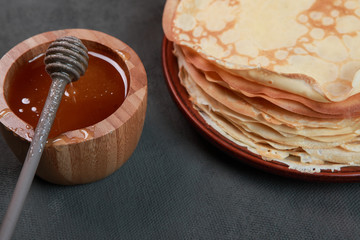 pancakes with berries, jam, honey and chocolate, sprinkled with powdered sugar and cinnamon