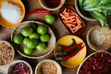 Top view background of various spices in wooden bowls on table, copy space