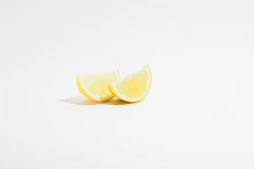 two lemon slices on a white background