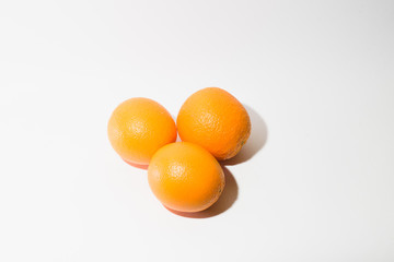 Three oranges on a white background