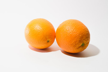 two oranges on a white background