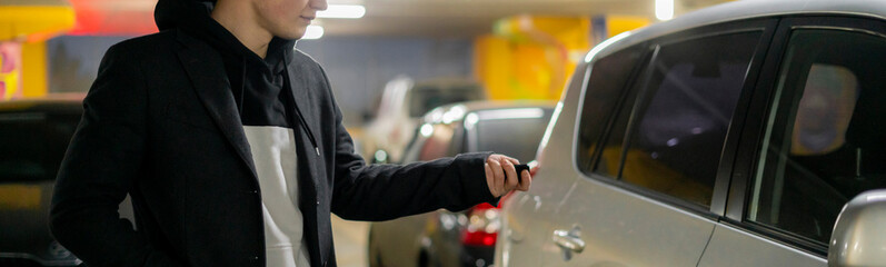 man opens his car in the underground parking zone f