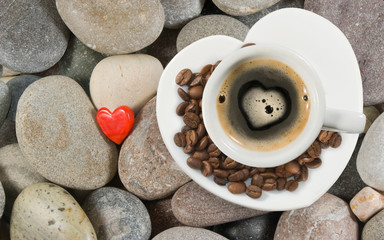 cup of coffee on the stone and stylized heart