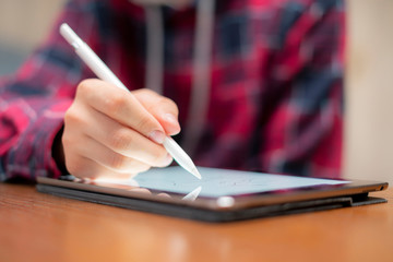 close up hand with digital pen draw on tablet