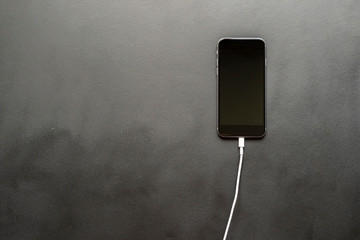 charging wire inserted in smartphone isolated b