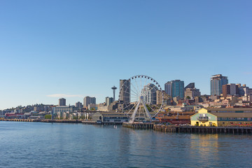 A view on Seattle city from the Puget Sound bay waters, USA. Cityscape on a sunny afternoon in summer.