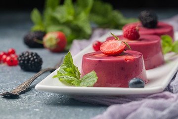 Summer dessert with berries and yogurt as a jelly pudding