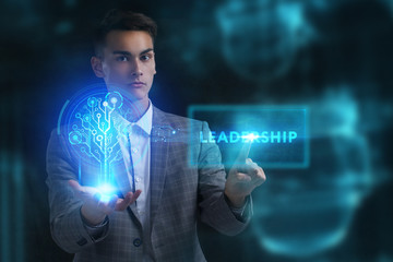 The concept of business, technology, the Internet and the network. A young entrepreneur working on a virtual screen of the future and sees the inscription: Leadership