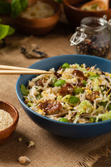Fried veal, with rice, Chinese cabbage and mushrooms. Sprinkled with sesame and soy sauce.