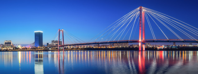 panorama night city of Krasnoyarsk bridge in lights