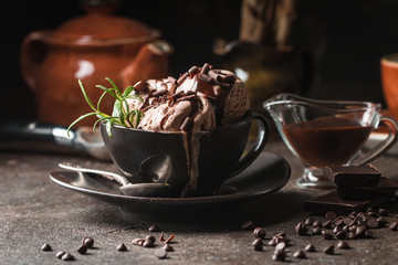 Chocolate coffee ice cream balls in a bowl over dark background