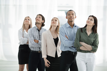 young business team looking up at copy space.